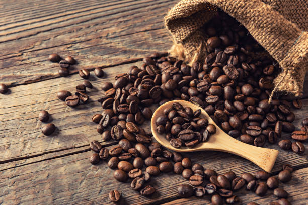 istock Coffee beans on wooden background 1327752188