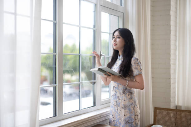 istock Asian girls reading in a cafe 1327754104