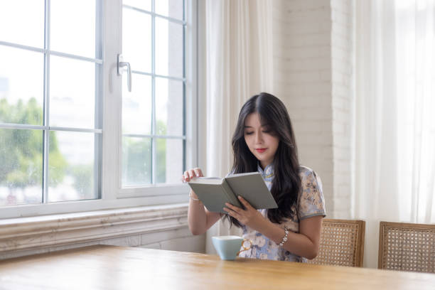 istock Asian girls reading in a cafe 1327754127