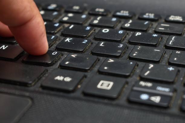 istock someone's hand pressing the laptop keyboard 1327754984