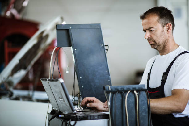 istock Mid adult repairman using laptop while working in a workshop. 1327756622