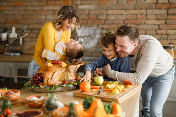 istock Happy family having fun during Thanksgiving day in the kitchen. 1327758131