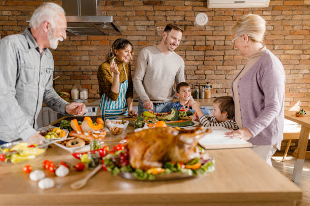 istock Happy multi-generation family making Thanksgiving lunch in the kitchen. 1327758157