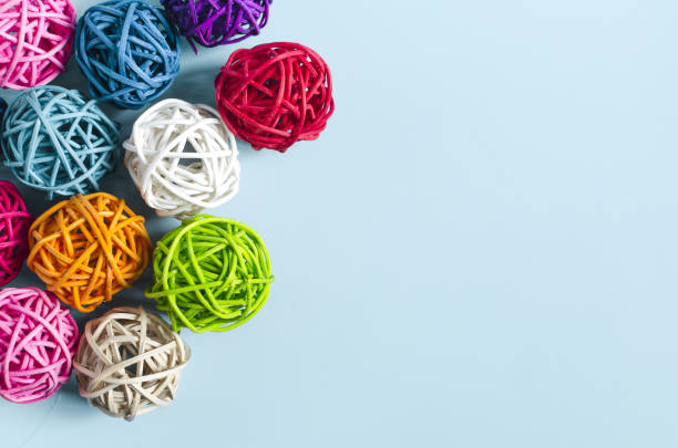 Balls of colored threads on a blue background. Decor made of colored threads on a light background of the mine space