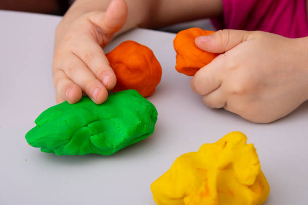 istock Toddler boy doing sensory playful exercise, close up 1327758989