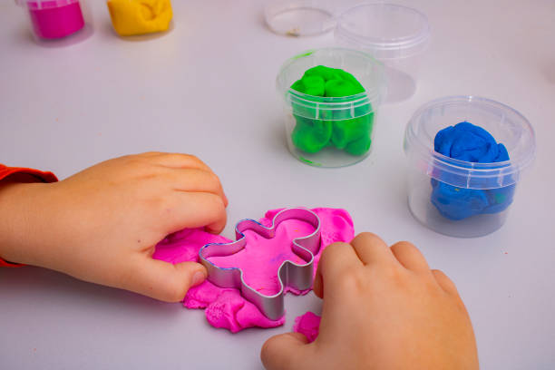 istock A kid playing with colourful clay, top view 1327758995