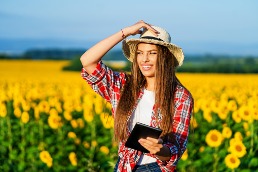 Female farmer in sunflower field