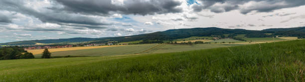 istock Panoramic view to summer Czech landscape with small vilage Chlum and hill Klet at dramatic cloudy sky 1327760188