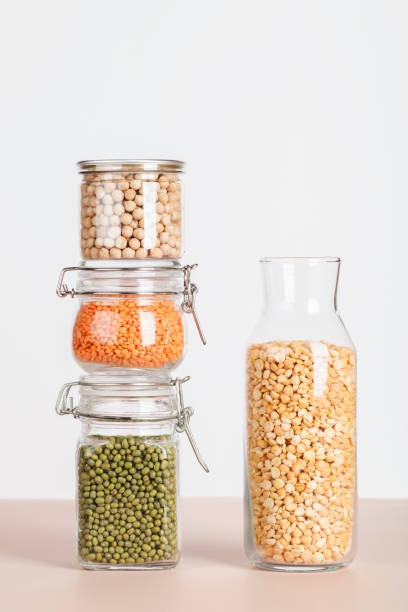 istock Vegan protein source. peas, chickpeas, lentils, mung in glass jars on white and beige background. Healthy vegetarian food. copy space 1327760356
