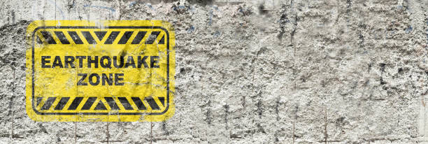 istock Yellow earthquake zone sign on wall background 1327760437