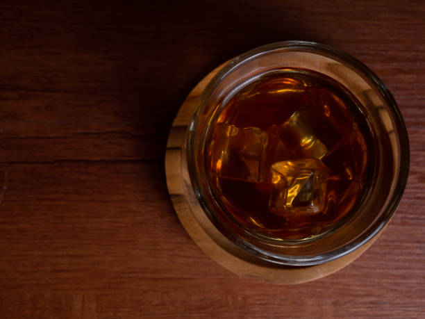 istock A cup of iced coffee on a wooden table with a jar container 1327760963