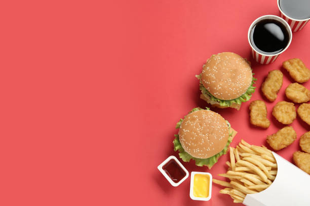 istock Flat lay composition with delicious fast food menu on red background. Space for text 1327762228