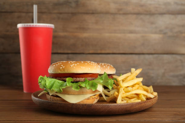 istock Delicious fast food menu on wooden table 1327762297