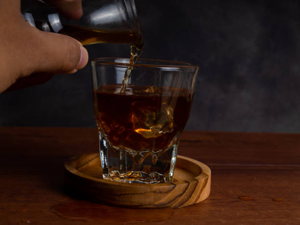 istock A cup of iced coffee on a wooden table with a jar container 1327762407