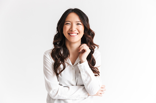 Little emotional teen girl in white shirt 11, 12 years old on an isolated white background. Children's studio portrait. Place text, to copy space for inscription, advertising children's goods.