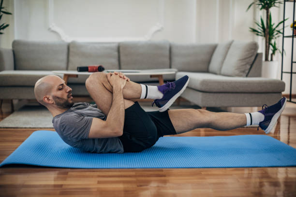 istock Man exercising on the floor at home 1327765654