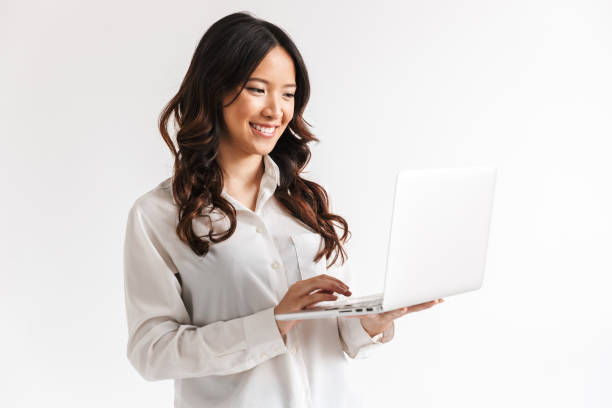 istock Smiling young asian businesswoman standing 1327765894