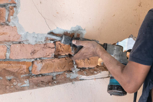 istock Worker use demolition hammer drill to break up wall surface. Motion blur intended. 1327765918