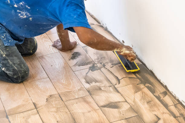 istock Worker applying grout onto newly laid ceramic tile. Motion blur intended. 1327766616