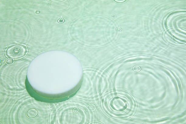 istock Empty white circle podium on transparent green clear water background 1327766678