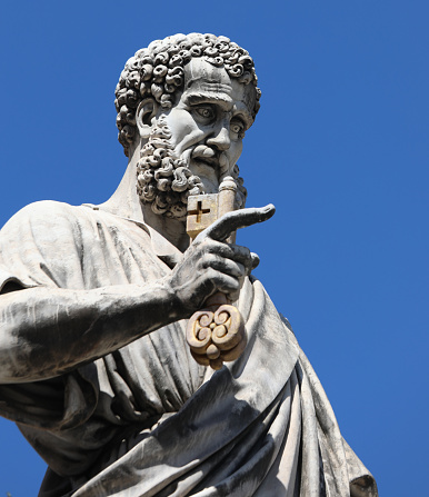 Vatican City, VA, Vatican - August 16, 2020: Statue of Saint Peter with Key of Heaven and blue sky in background