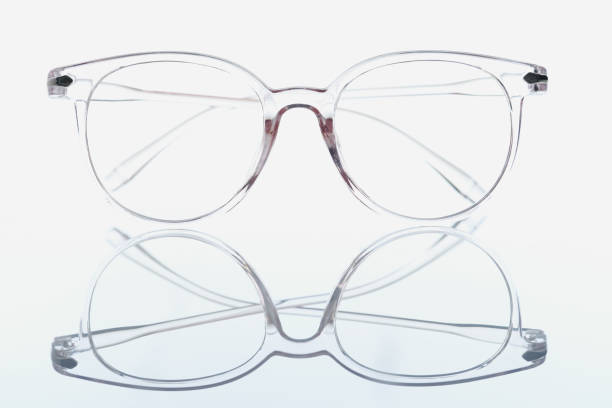 Closeup of transparent glasses for vision on white background with mirror reflection. Vision correction concept