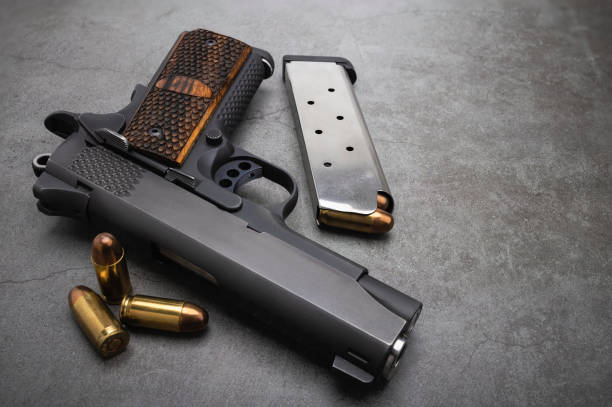 istock Semi automatic pistol hand gun with bullet magazine on texture background , Classic gun 1327766930
