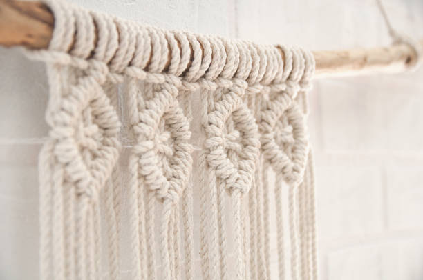 istock Boho wall mural made of natural color cotton threads using macrame technique for home and wedding decor in the production process 1327767956