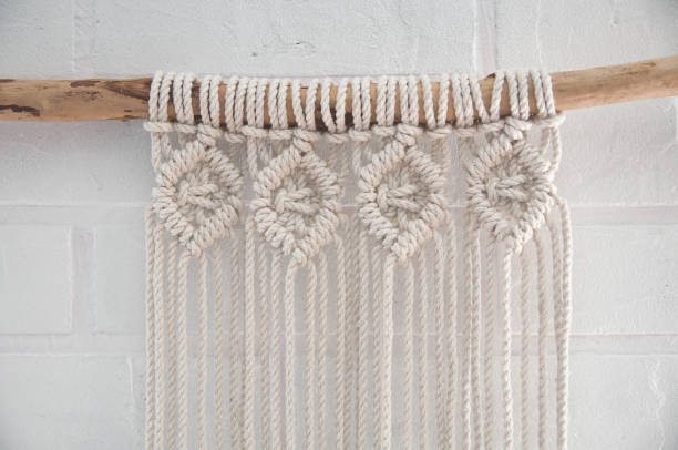 istock Boho wall mural made of natural color cotton threads using macrame technique for home and wedding decor in the production process 1327767961
