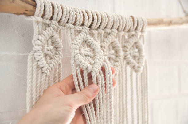 istock Boho wall mural made of natural color cotton threads using macrame technique for home and wedding decor in the production process 1327767972