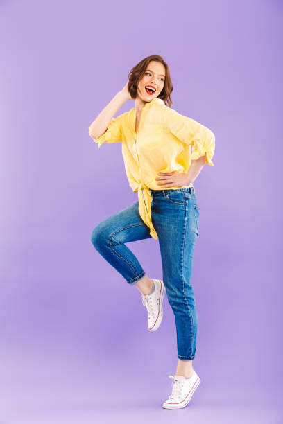 istock Excited woman posing isolated over purple wall background. 1327768257