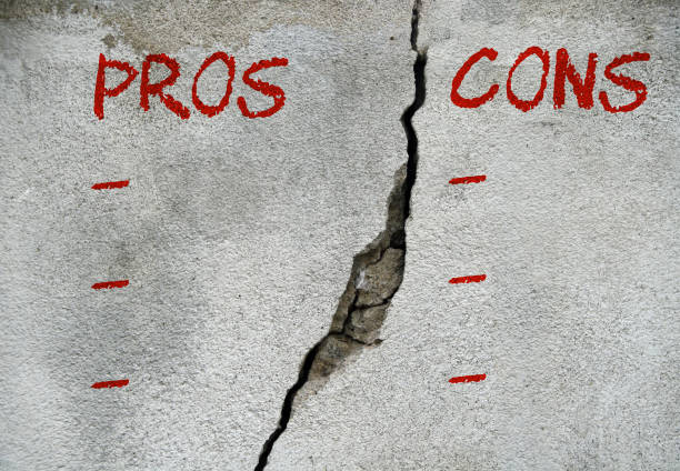 istock Pros cons concept - Pros and cons written on wall with a crack. 1327768384