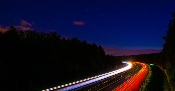istock lights of cars with night. 1327768398