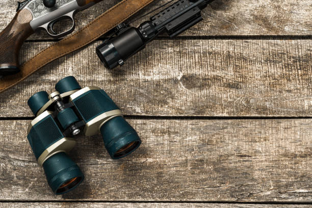 istock Various hunting equipment on old wooden background 1327768668