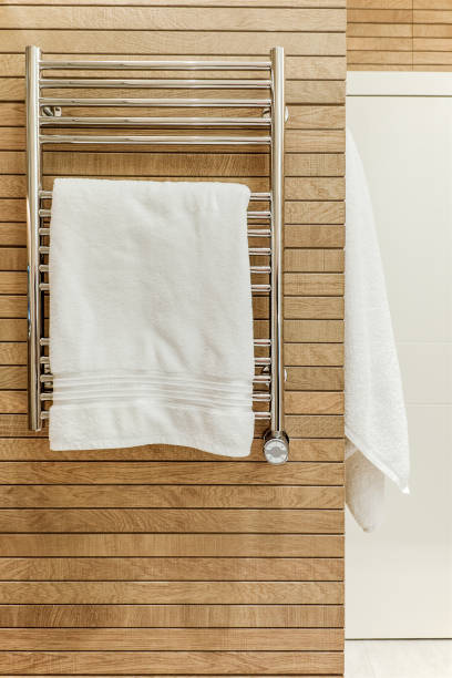 istock Modern bathroom interior with heated towel rail and wooden trim 1327769036