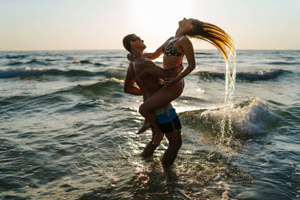 istock Loving young couple having fun in sea 1327769276
