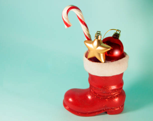 istock Santa red boot with candy cane and baubles. Christmas. New Year background with copy space 1327772424