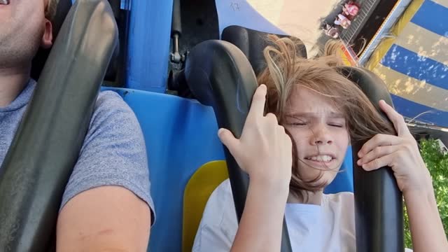 dad and daughter ride extreme attraction. adrenaline and fun in amusement park
