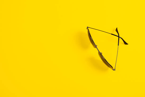 istock Sunglasses on yellow background. Minimalistic summer banner with copy space 1327773682
