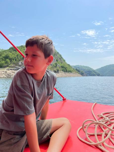istock Boy is enjoying on boat. 1327775307