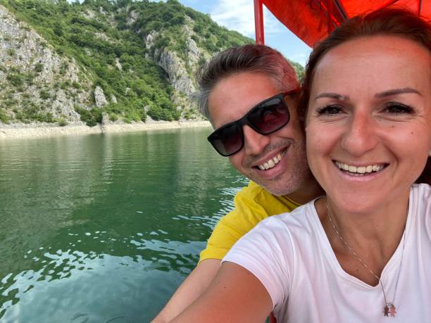 istock Couple enjoying on boat, taking selfies. 1327775435
