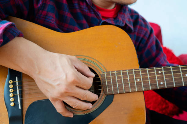 istock Close up of man hand playing guitar 1327776726