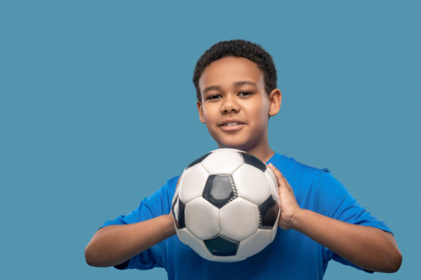 istock Attentive boy taking aim with ball in hands 1327776856