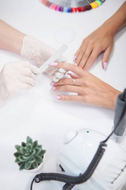 istock Professional manicurist doing nails of a client 1327780588