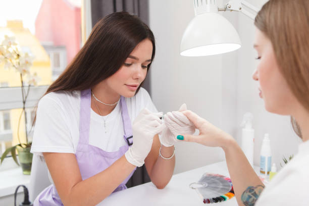 istock Professional manicurist doing nails of a client 1327780711