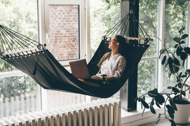 Businesswoman working on a hammock. Freelancer and her workspace. stock photo