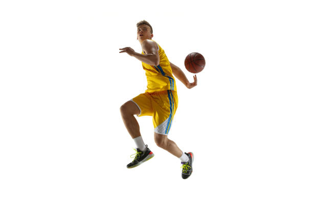 istock Side view. One young man, basketball player with a ball training isolated on white studio background. Advertising concept. Caucasian athlete in action. 1327784339
