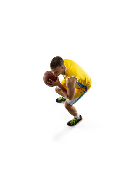 istock High angle view of young man, basketball player with a ball training isolated on white studio background. Advertising concept. Fit Caucasian athlete jumping with ball. 1327784340