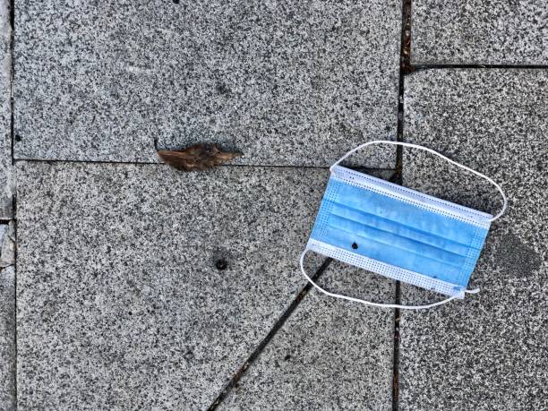 istock used health mask on ground 1327784871