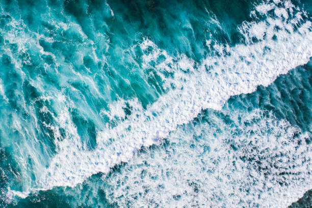 istock Big ocean waves hitting a coral reef. View from above. 1327784945